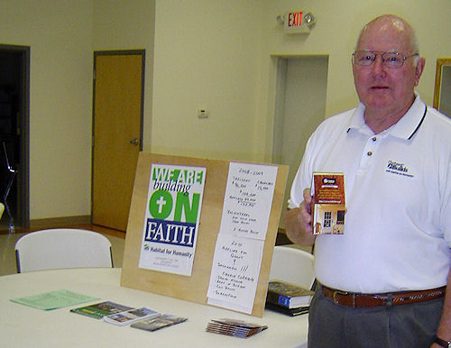 Ned Owens, holding a fund-raising paper bank for churches, explained how funds raised for the Lutheran Build project with Habitat for Humanity, will help build a home in Robertsdale.