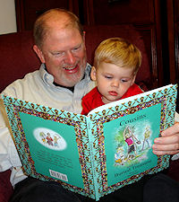 Phil Owen reads his new book to grandson Colton.
